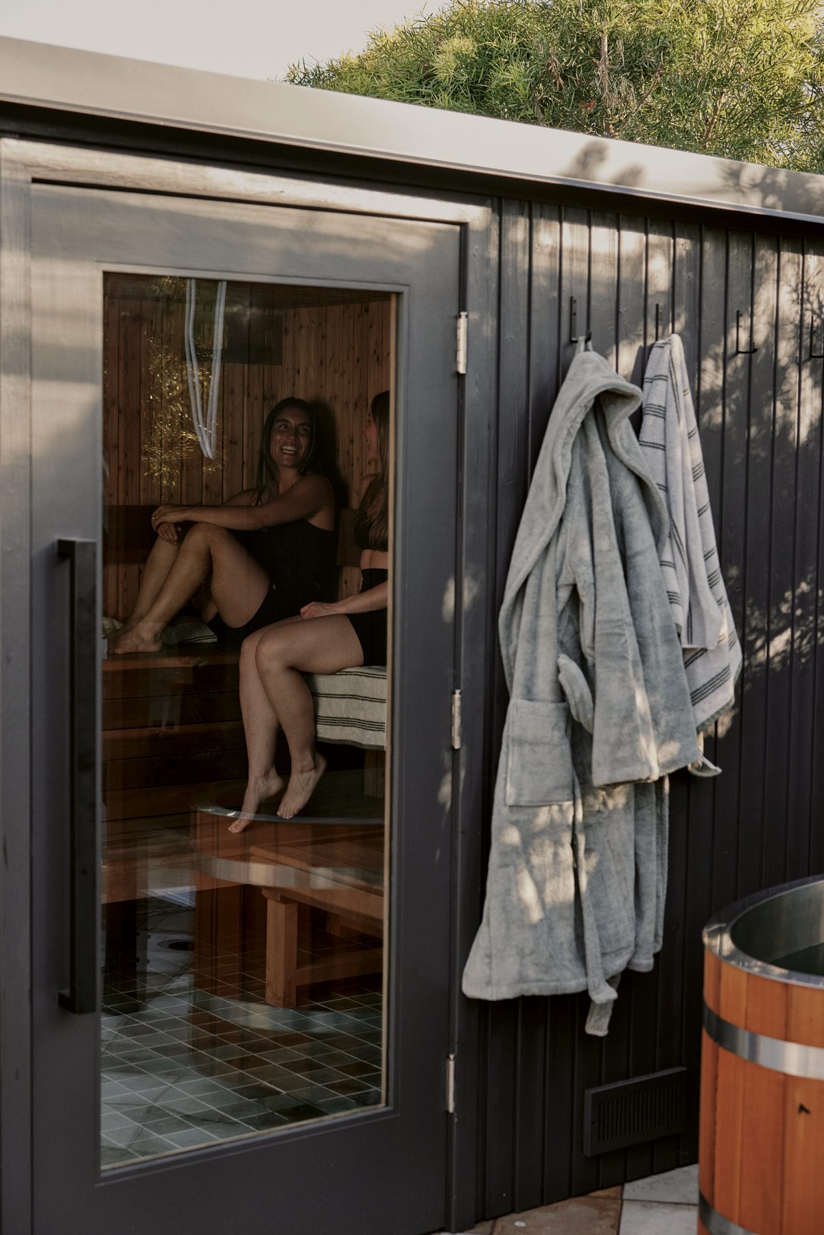 Two guests laughing inside the Wren sauna